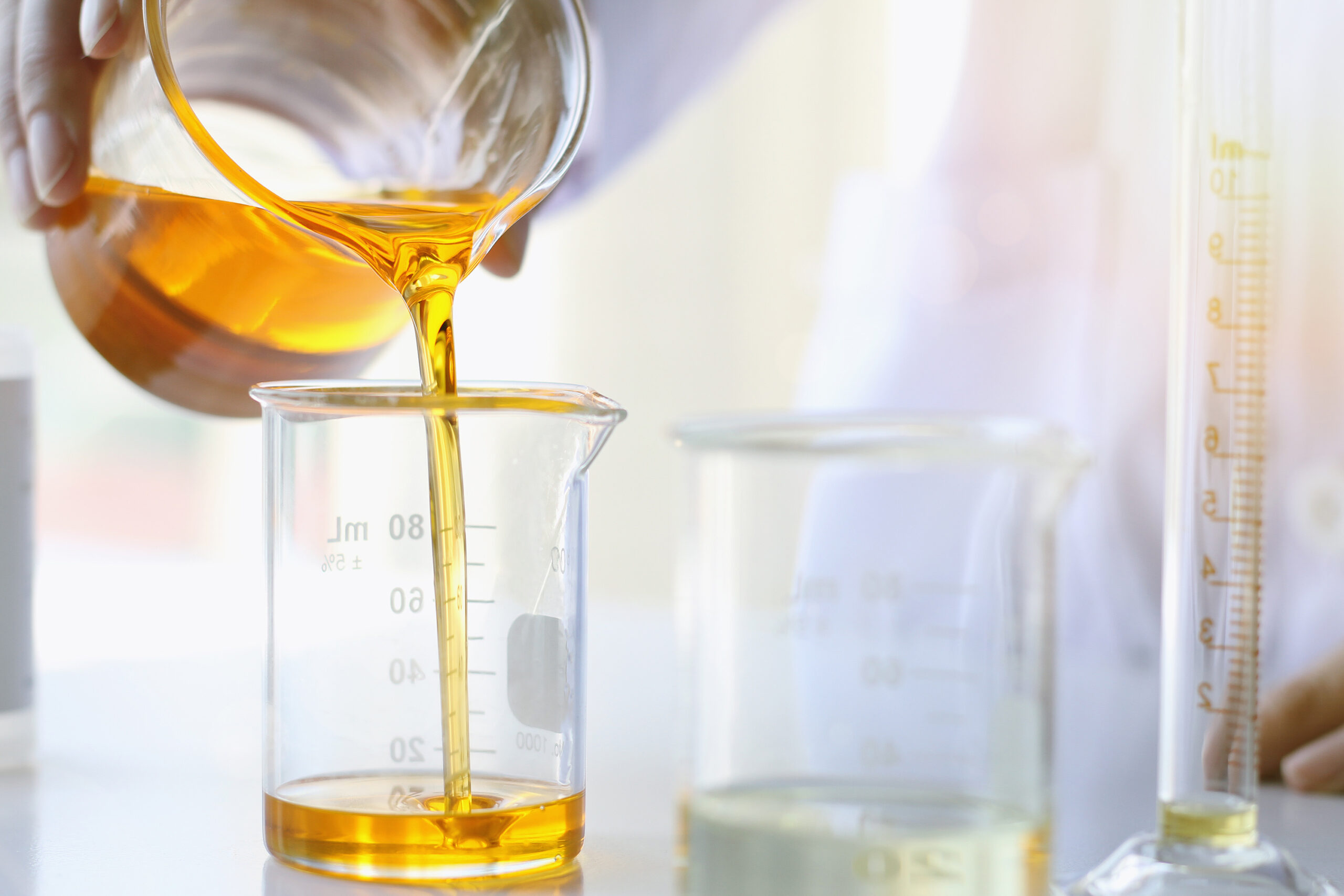 Oil pouring, Equipment and science experiments, Formulating the chemical for medicine, Organic pharmaceutical, Alternative medicine concept. (Selective Focus)